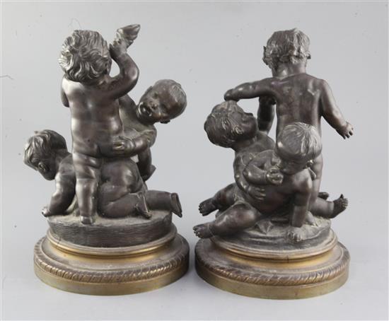 A pair of 19th century bronze groups of wrestling putti, height 10.75in.